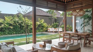 A covered outdoor area with a pool, seating, and plants. - Cocana Resort Gili Trawangan (Gili Trawangan)