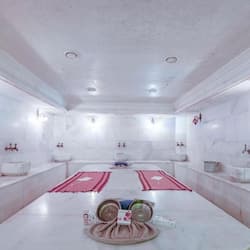 Enjoy a spacious room with a central meeting area, two restrooms, and high ceilings.