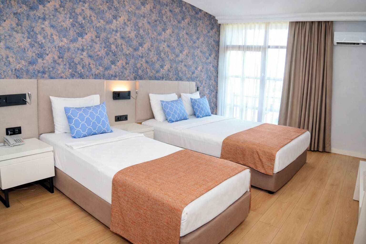 Standard Triple Room | Minibar, in-room safe, laptop workspace, blackout curtains