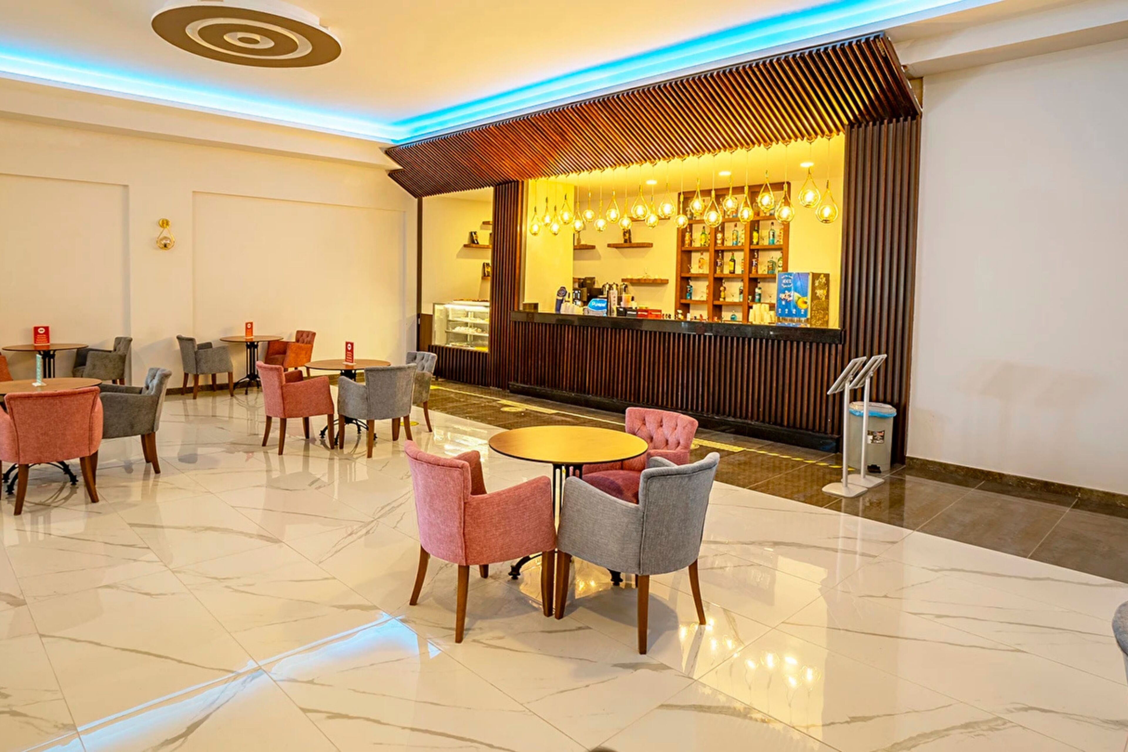 A lobby with a reception desk, seating area, and a modern design.