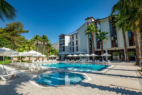 Seasonal outdoor pool, open 8:00 AM to 6:30 PM, pool umbrellas