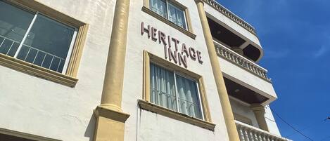 A building with the sign "Heritage Inn" on the facade.