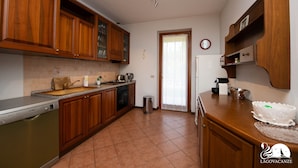 A kitchen with wooden cabinets, a Bosch dishwasher, and a sink.