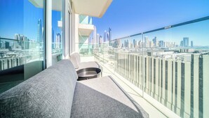 Un balcón moderno con vistas a la ciudad, un sofá y una mesita.