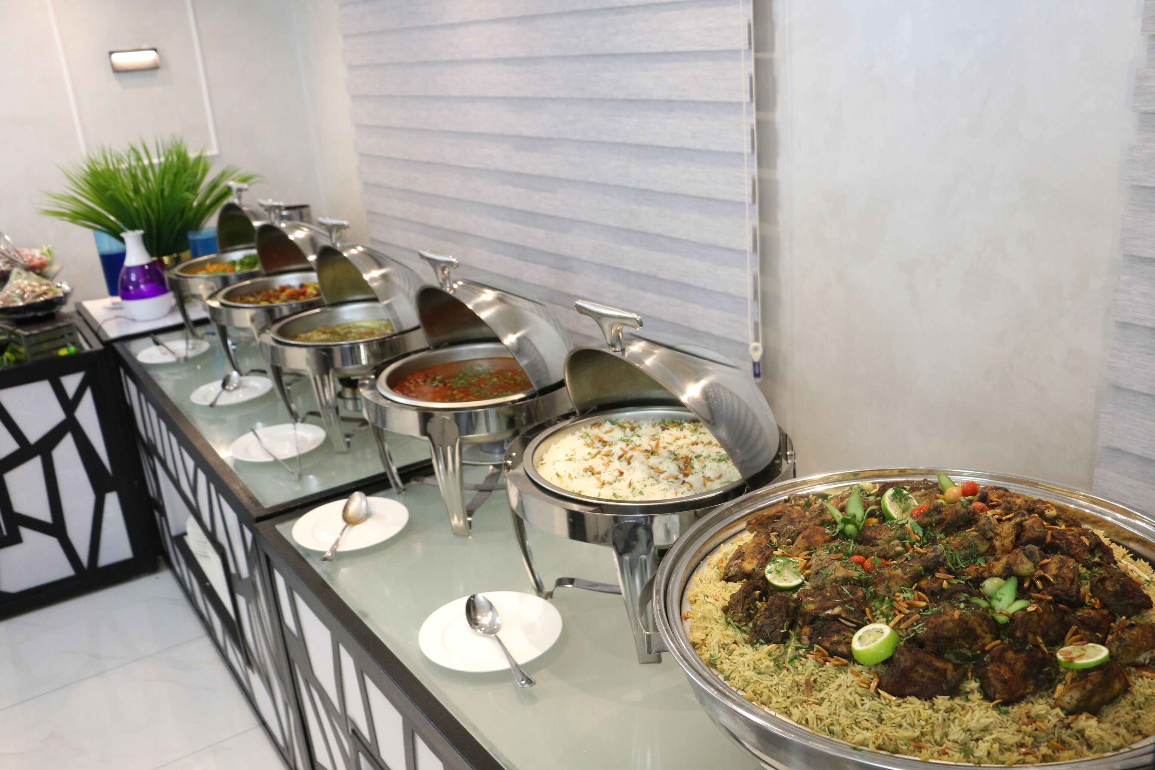 A buffet with various dishes, including rice, meat, and vegetables.