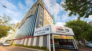 A hotel building with a sign for 'Olleh Spa' and a smaller sign for 'Olleh Spa Hotel'.