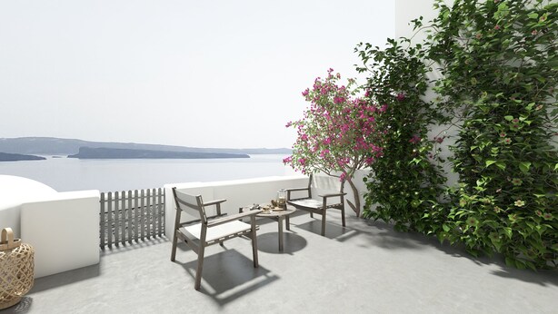 A balcony with a view of the sea, a white wall, and a plant with pink flowers. - Superior Suite with Caldera View (Thira - Santorini)