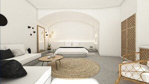 A modern, minimalist bedroom with a large bed, bedside tables, a round coffee table, and a wicker chair. - Superior Suite with Caldera View (Thira - Santorini)
