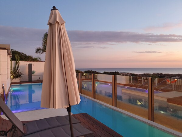 Seasonal outdoor pool, open 10:00 AM to 9:30 PM, pool umbrellas