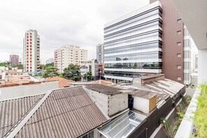 A modern urban landscape with high-rise buildings, a mix of residential and commercial structures, and a clear sky. - Charlie For You Moema (São Paulo)