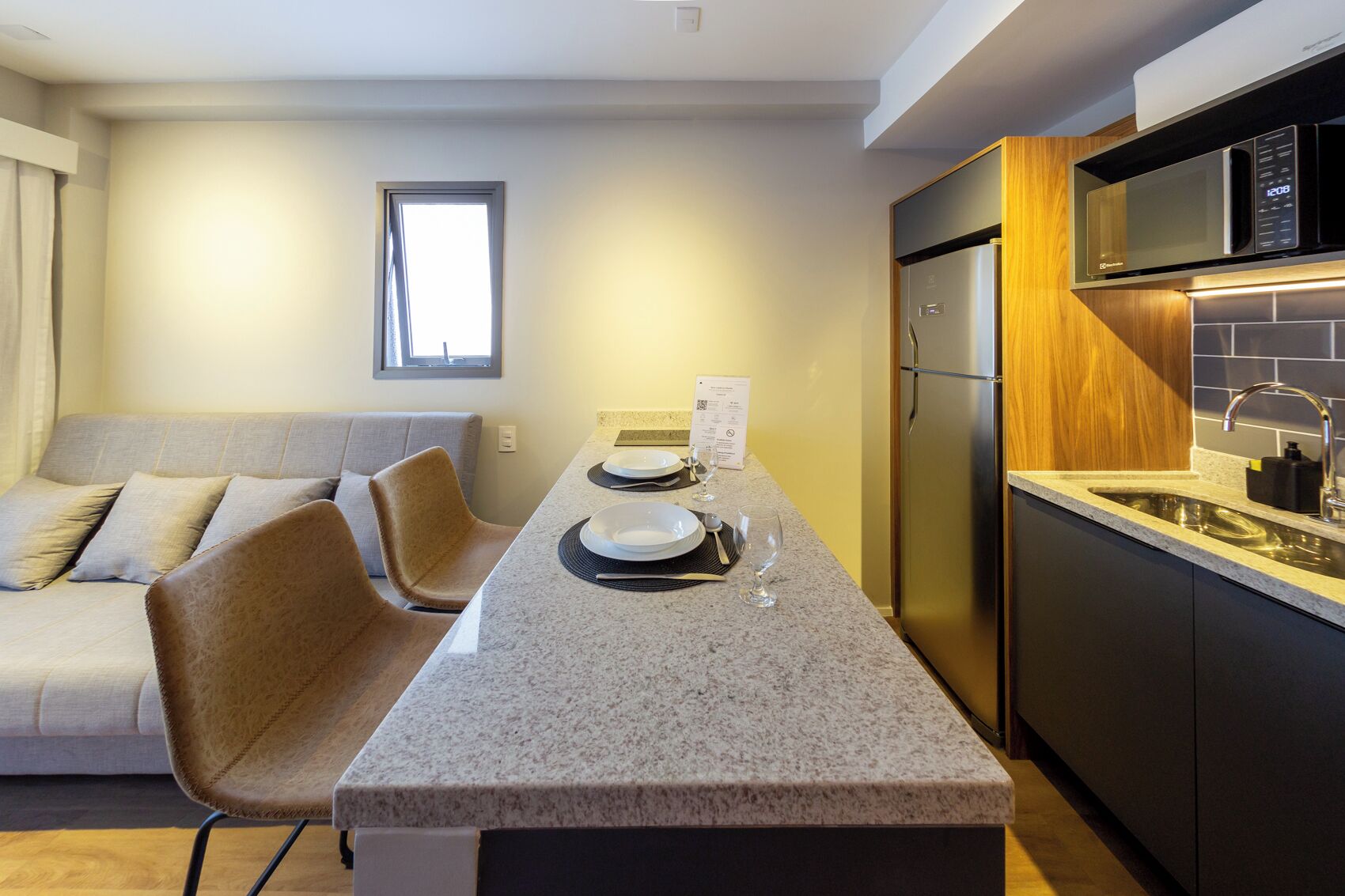 A modern kitchen with a granite countertop, stainless steel appliances, and a built-in oven.