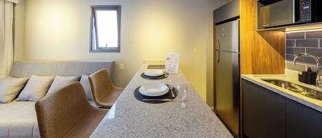 A modern kitchen with a granite countertop, stainless steel appliances, and a built-in oven.