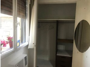 Guests can hang their clothes in the closet with a convenient hanging rod.