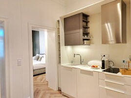 Family Suite, 2 Bedrooms, Kitchenette, City View | Memory foam beds, in-room safe, individually decorated