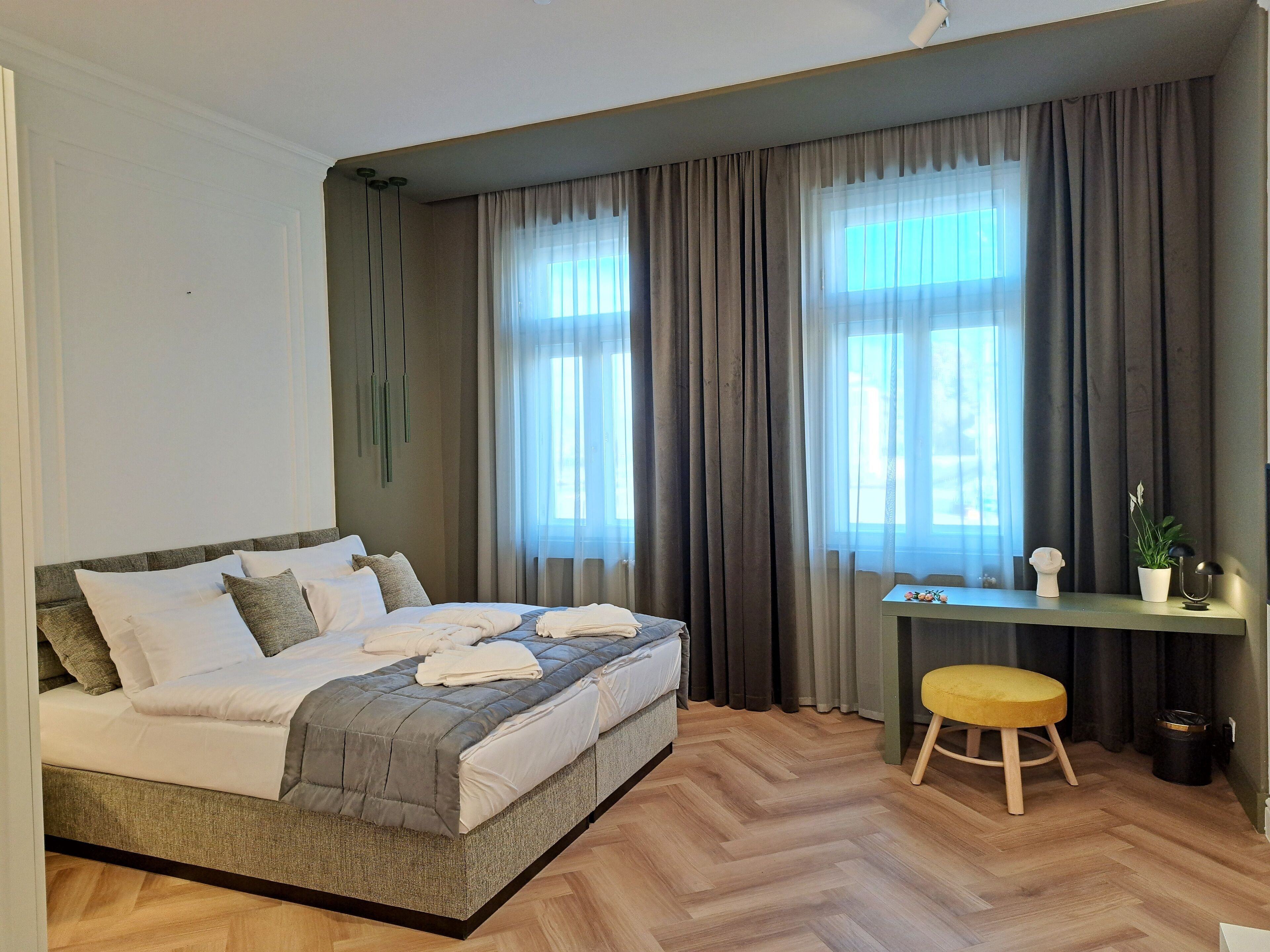 A modern bedroom with a bed, a desk, and a chair.