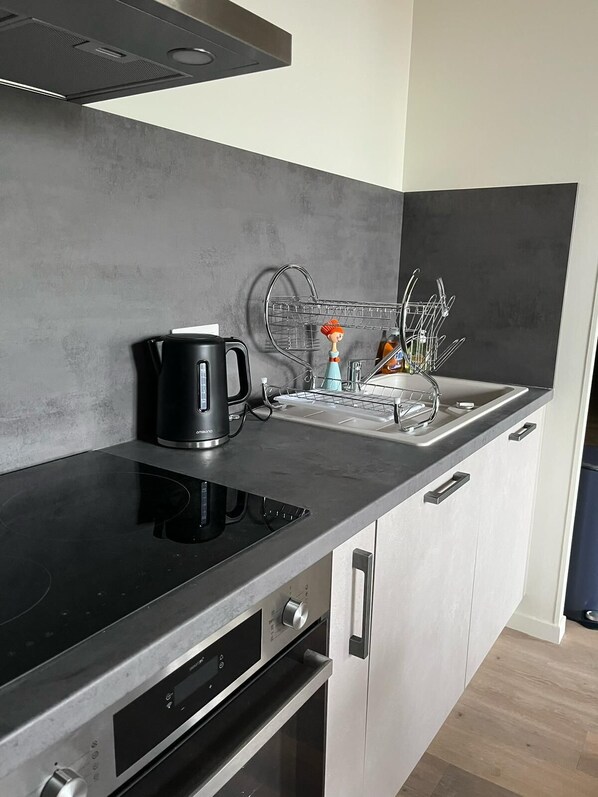 Fridge, microwave, electric kettle, cookware/dishes/utensils