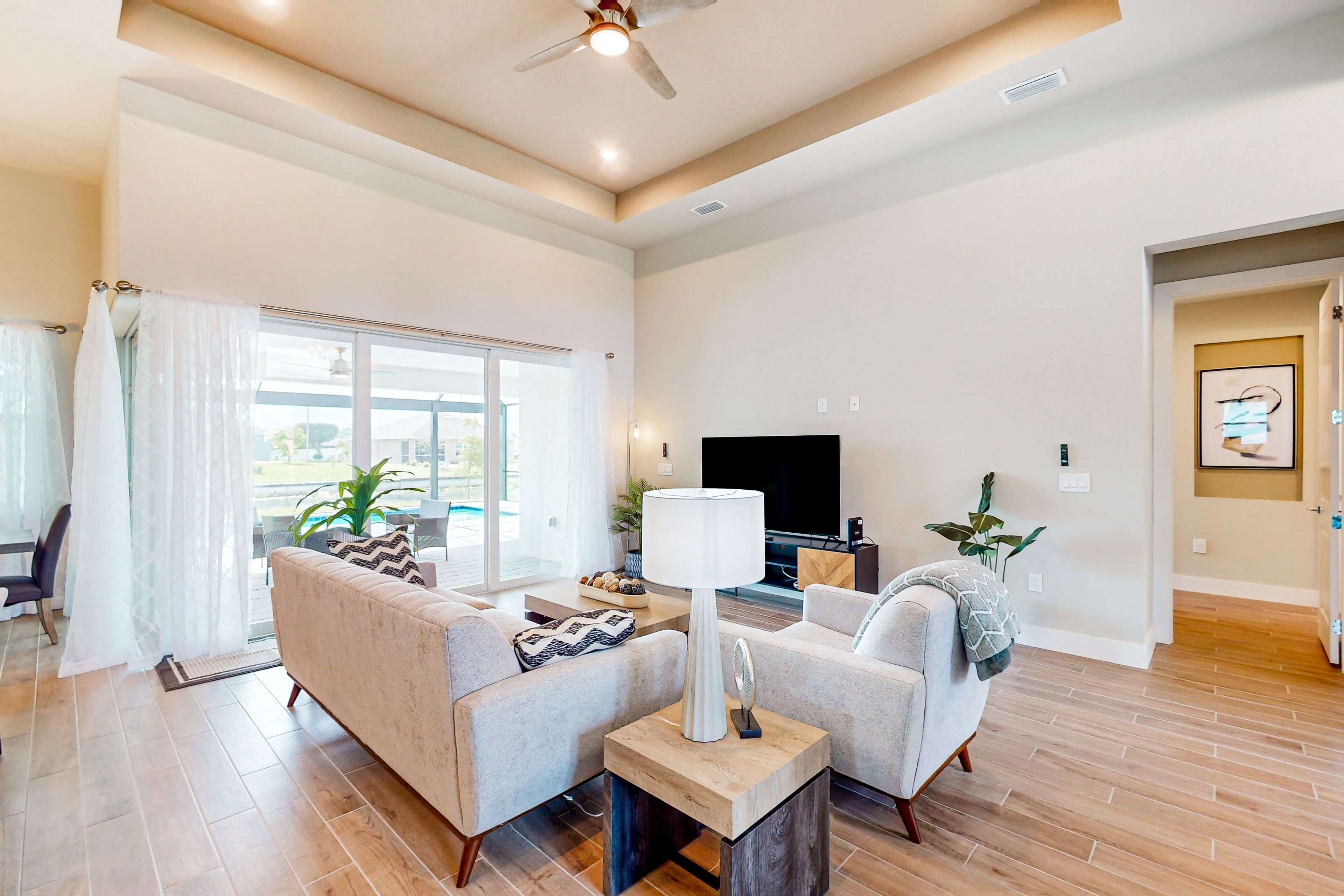 Waterfront home with heated pool, expansive patio, full kitchen, AC, and W/D