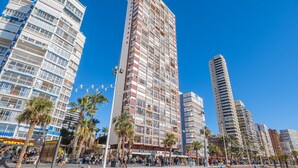 A high-rise building with multiple balconies and a clear blue sky. - Las Damas 12-E Levante Beach (Benidorm)