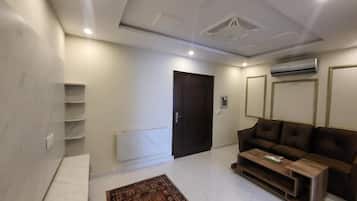 Deluxe Apartment | Living room | 32-inch LCD TV with cable channels