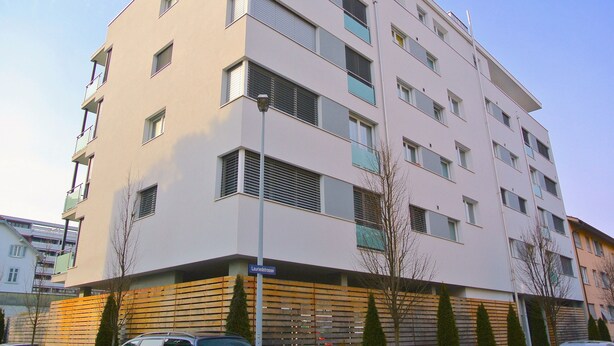A multi-story building with a flat facade, several balconies, and a street sign indicating "Laurenzstrasse". - Nest - Lauriedstrasse 9 (Zug)