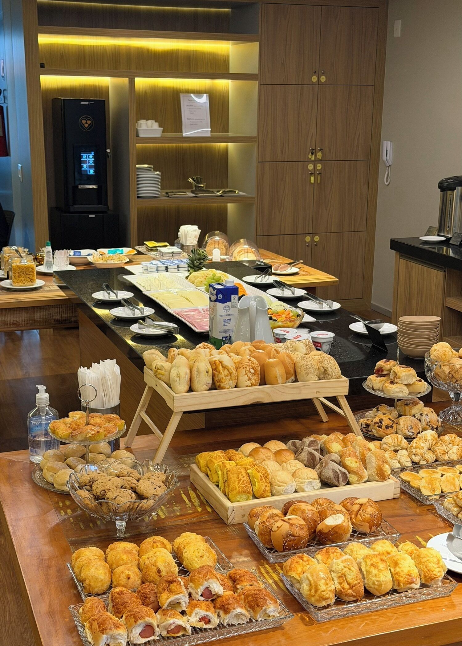 A buffet with various baked goods and beverages.