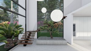 A modern interior with a staircase, a small garden, and large windows offering views of trees and flowers. - AMA VILLAS - Luxury Collection -  **BRAND NEW ****35% DISCOUNT AVAILABLE (Rose Hall)