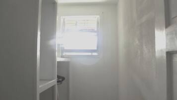 A narrow hallway with a window at the end.