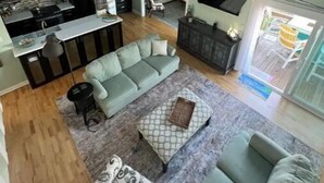 A modern living space with a kitchen, dining area, and seating area.