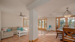 A spacious living area with a sofa, coffee table, and dining table. - Well-appointed home just steps from the Colorado river! (Needles)