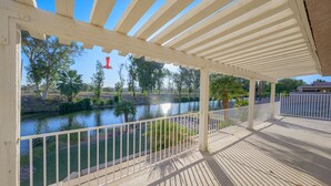 A covered outdoor area with a view of a river and trees. - Well-appointed home just steps from the Colorado river! (Needles)