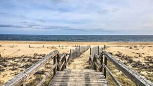 A wooden boardwalk leading to a beach with a clear view of the ocean. - Bethany Townhome-50ft to Shore! (Bethany Beach)