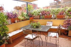 Relax on the rooftop terrace surrounded by lush potted plants and enjoy the views.