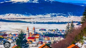 A town with colorful buildings and a church with two towers. - 1 bdr Apt, Kupres, centar, beautiful and uniqe plase (Kupres)