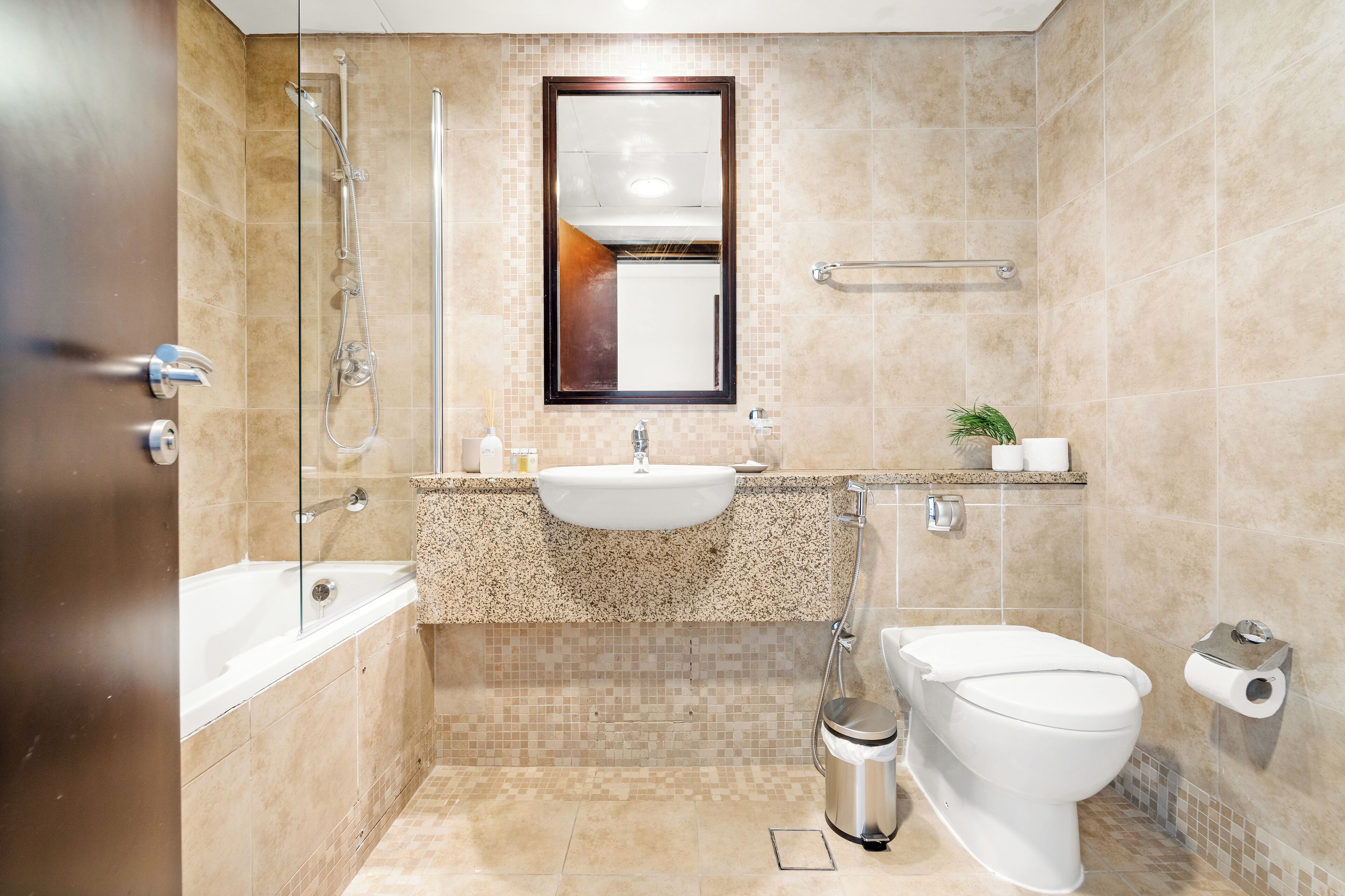 A bathroom with a bathtub, a sink, a toilet, and a shower.