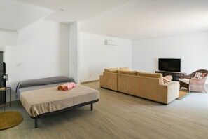 A modern living room with a bed, sofa, and television. - Spectacular House. Ocean Vistas (Benalmádena)
