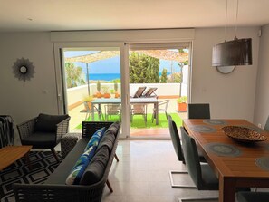 A modern living room with a large sliding glass door leading to an outdoor patio area. - Spectacular House. Ocean Vistas (Benalmádena)