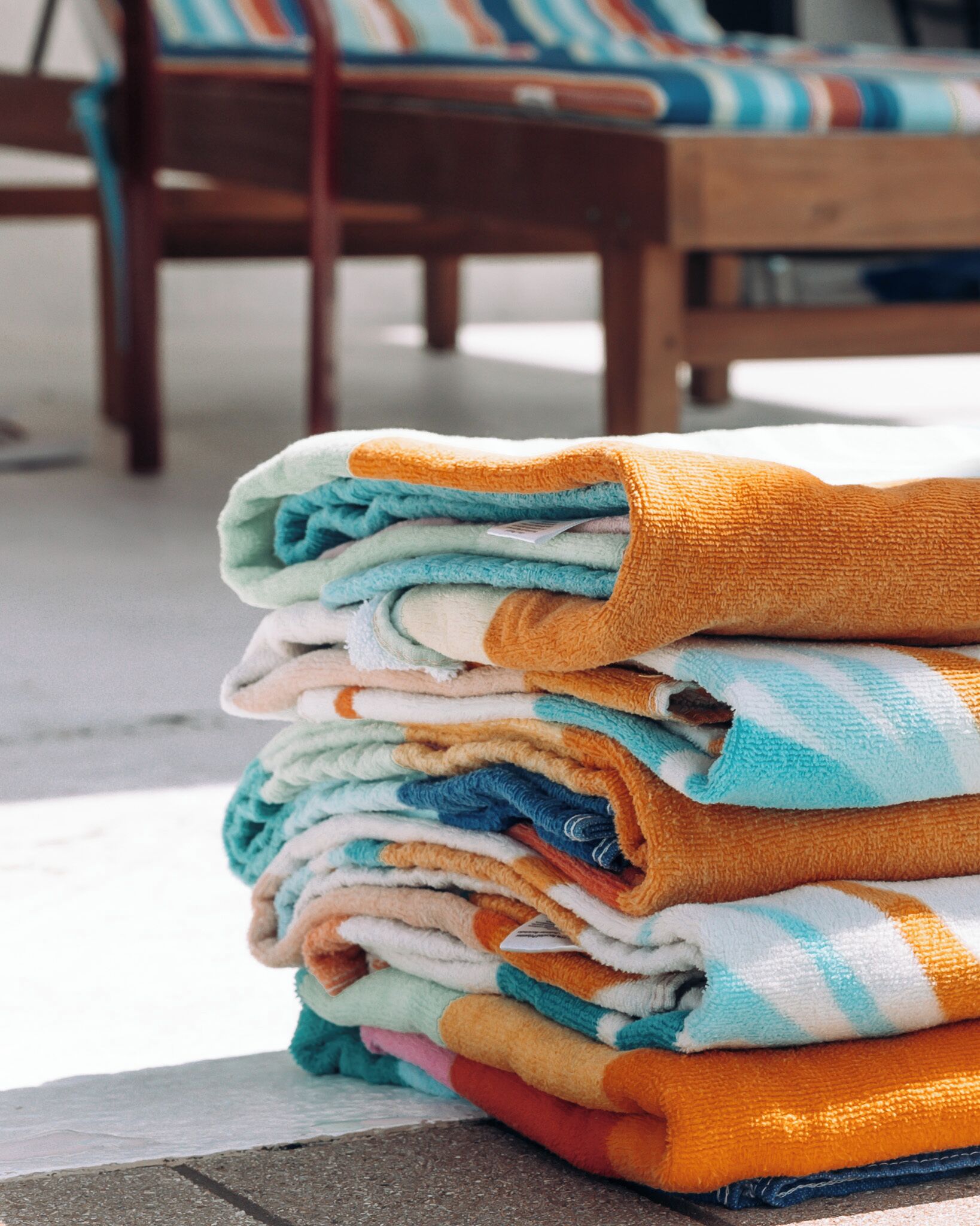 A stack of folded towels in various colors.