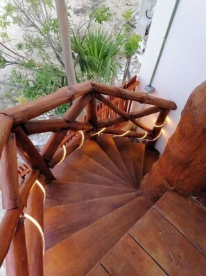 Stunning spiral staircase with a rustic design, featuring a series of steps ascending in a helical pattern.