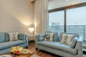 Relax in this stylish living room with a city view, featuring a sofa, side table, and lamp.