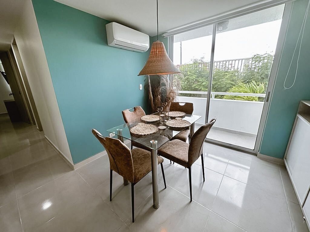 A dining area with a glass table, woven placemats, and brown upholstered chairs.