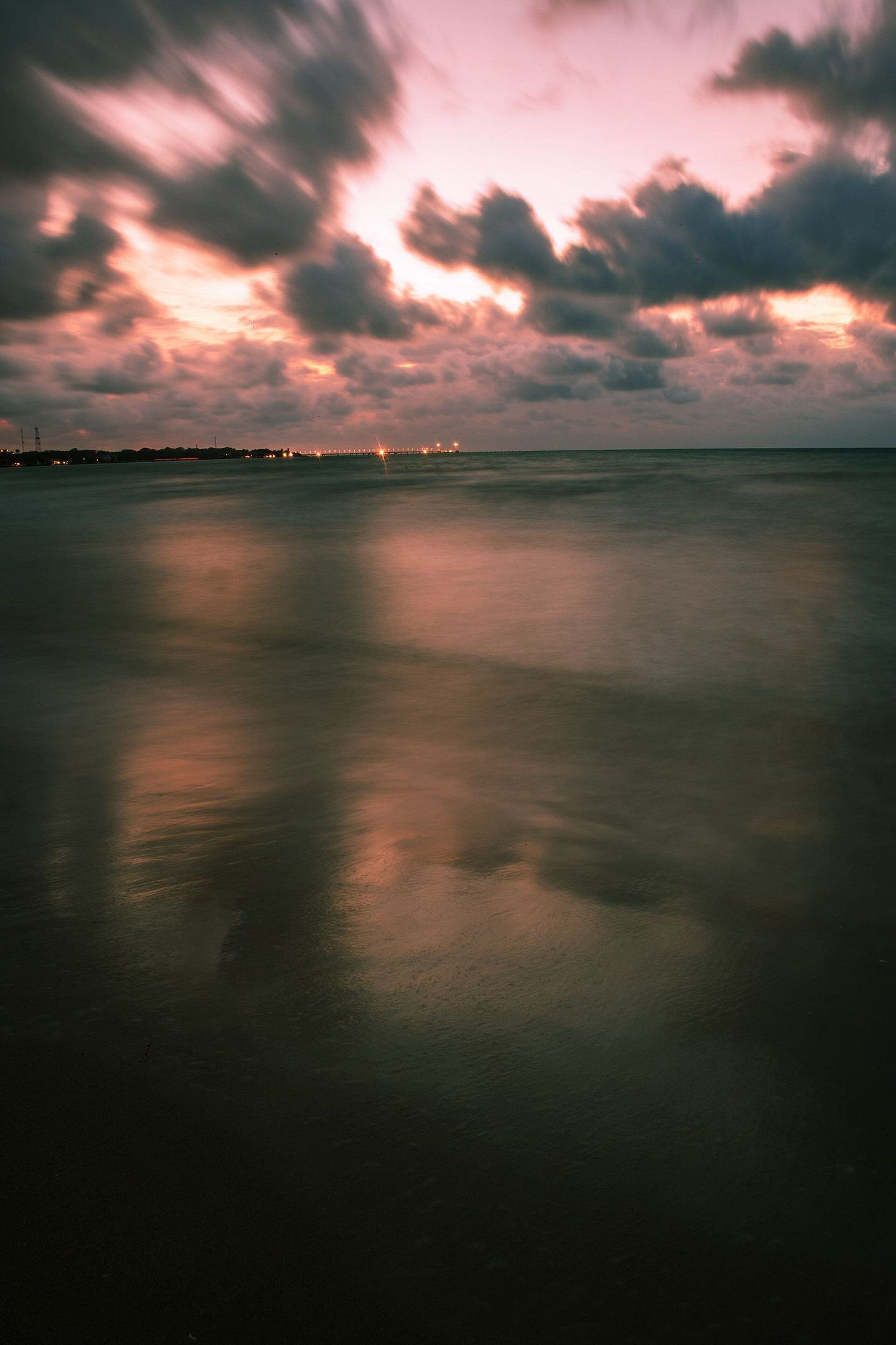 A calm body of water reflecting the sky.