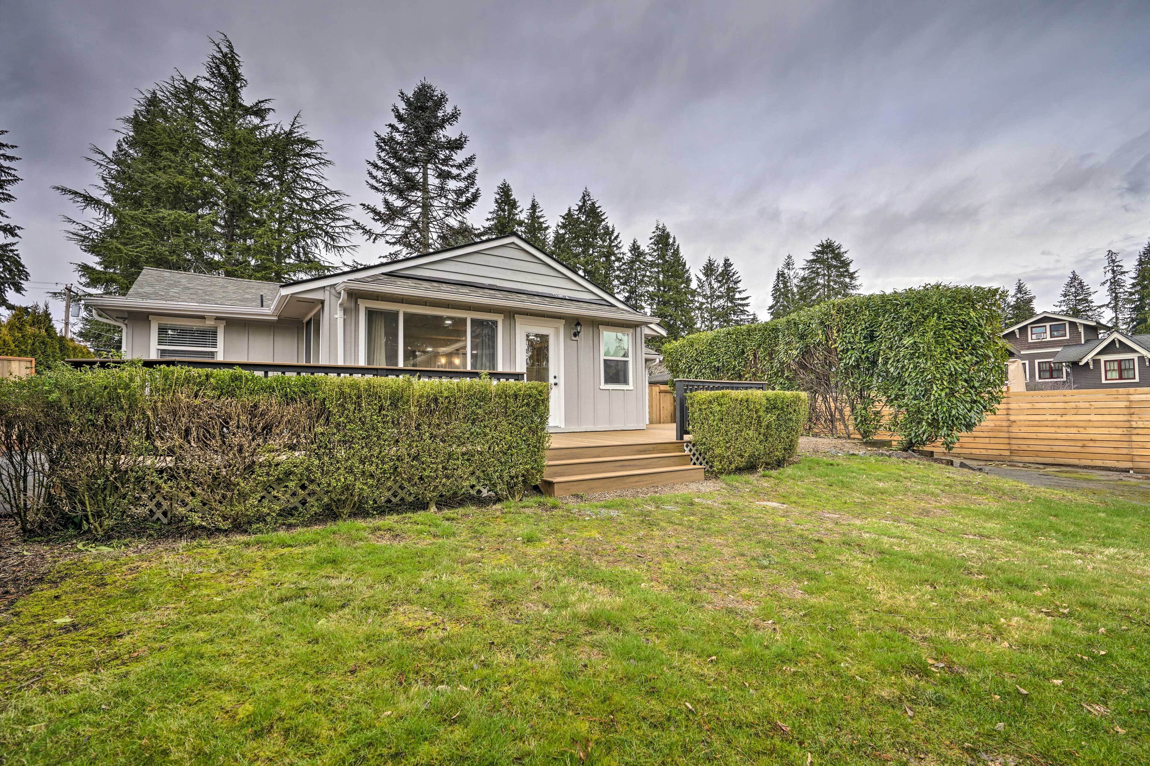 A single-story house with a front porch, a small deck, and a well-maintained lawn.