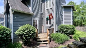 A two-story house with a wooden front porch and a welcome sign. - 🌷 Hidden Springs Chalet | Quiet Getaway w/ Pool Access, Fireplace, Forest View (Somerset)