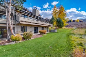 A modern two-story house with a large front lawn, a covered patio, and a view of the surrounding hills. - Chatham Crossing 2159 | 2 Living Rooms | Mtn View | Private Patio | Private Garage (Park City)