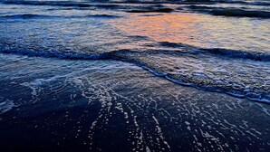 A beach with waves at sunset. - Bayfront Home, Shared Pool/Spa, Gazebo, Playground (Port Isabel)