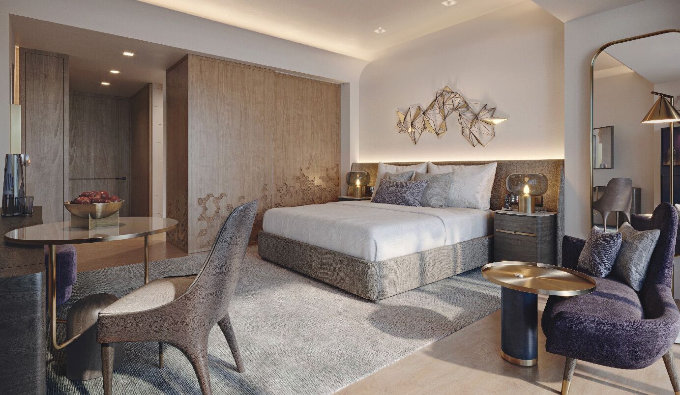 Un dormitorio moderno con cama, mesitas de noche, una silla, una mesa redonda y un adorno en la pared.