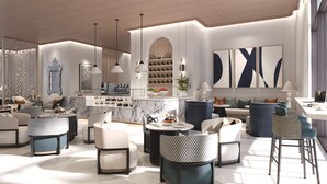 Un espace lounge moderne, doté de sièges, d’un bar à café et d’éléments décoratifs.