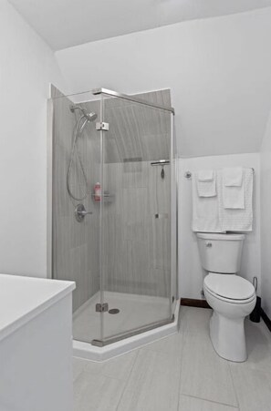 A modern bathroom with a glass-enclosed shower, a white toilet, and a white sink. - Gorgeous Mountains Views & Private Stream in Secluded Oasis (Gilboa)