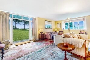 A living room with a large window, a sofa, a lamp, and a rug. - The Wool Barn, Simonsbath (Exford)
