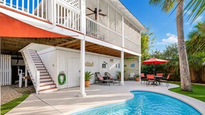 A two-story house with a pool, outdoor seating, and a covered patio area. - Relaxing Getaway w/ Private Pool (Tybee Island)